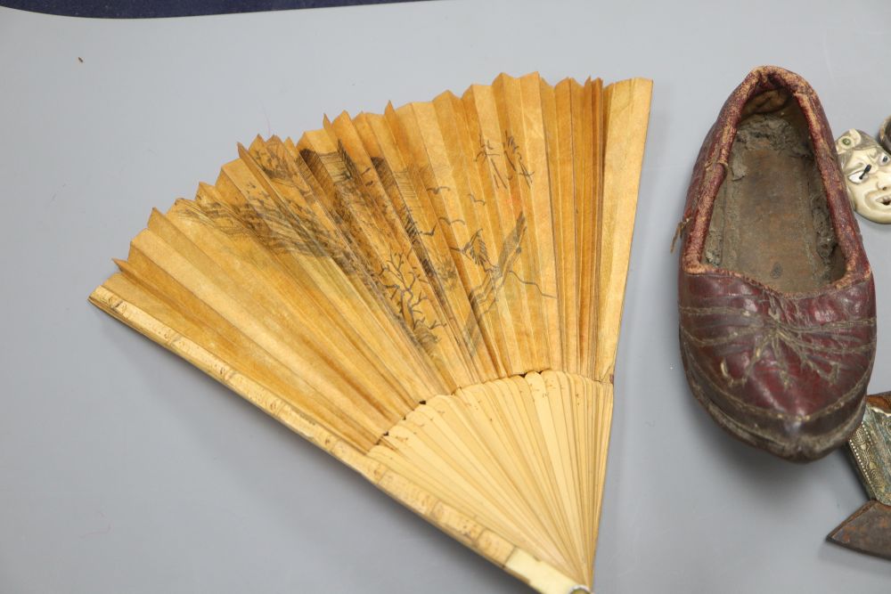 A Japanese ruyi sceptre okimono, together with a stamped leather tobacco pouch, a tinder strike, a leather Chinese childs shoe, a fan,